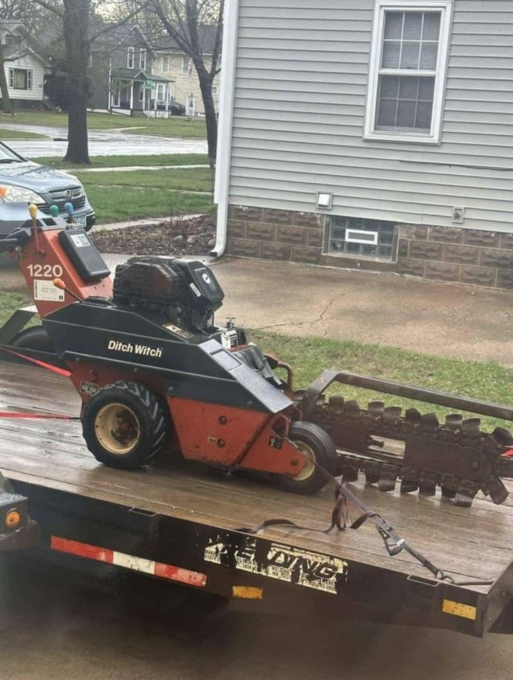picture of an electrician with a ground digging machine on a trailer