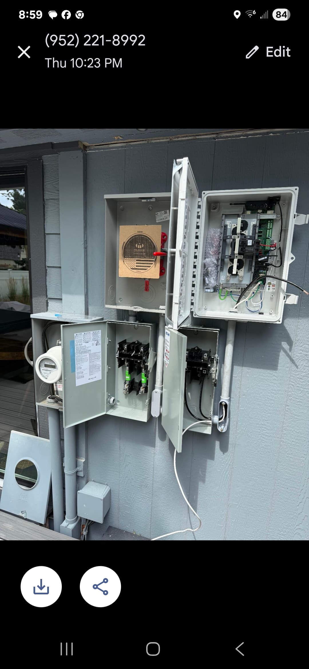 Exterior electrical equipment with open disconnects, meter socket, and control panel during installation.