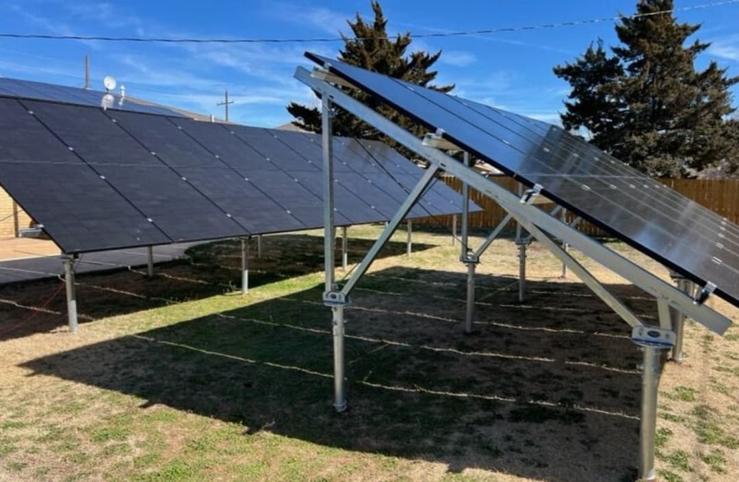 Ground-mounted residential solar panel array providing clean renewable energy