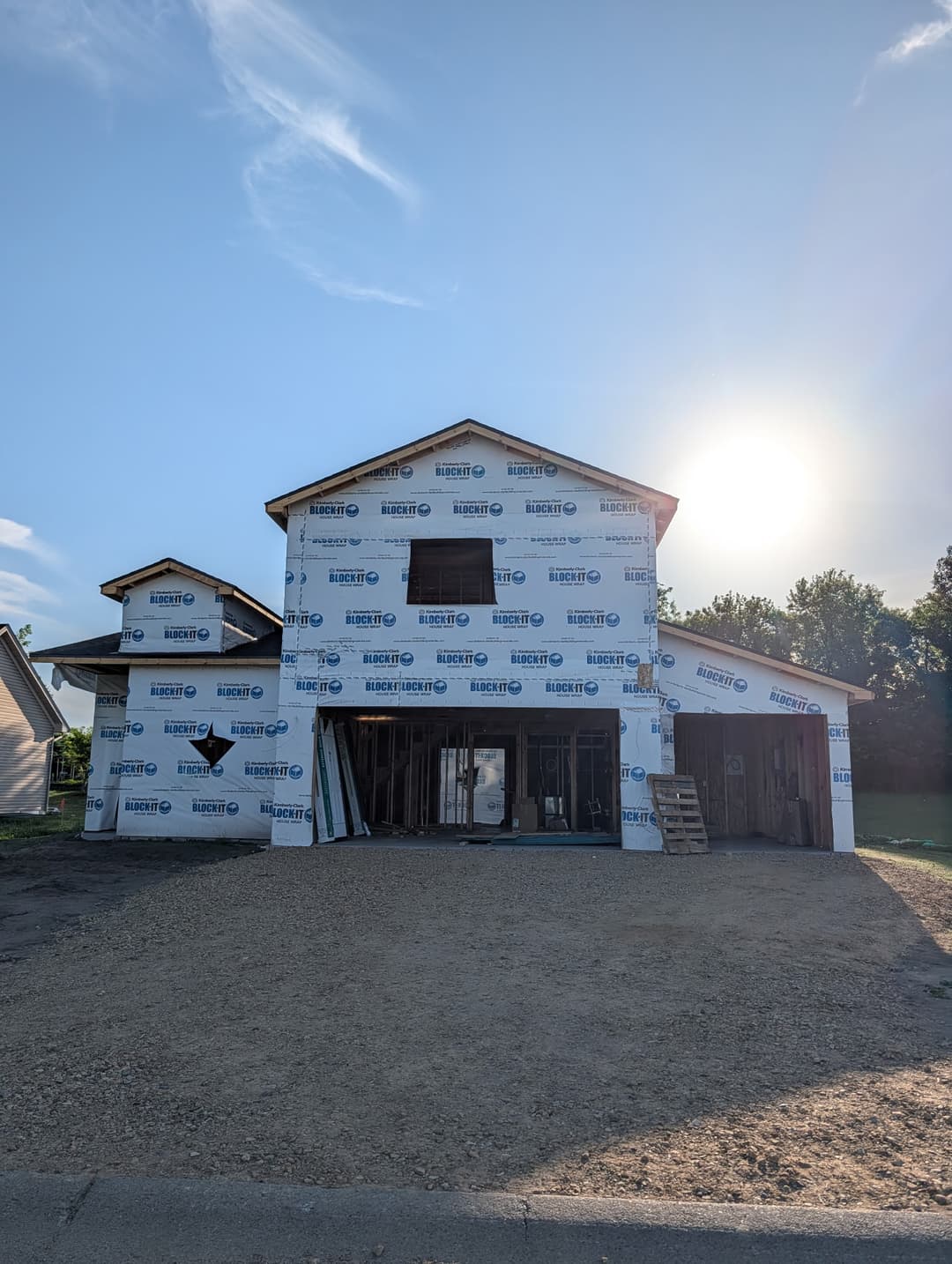 New home construction wrapped in house wrap and ready for electrical rough-in and service installation.