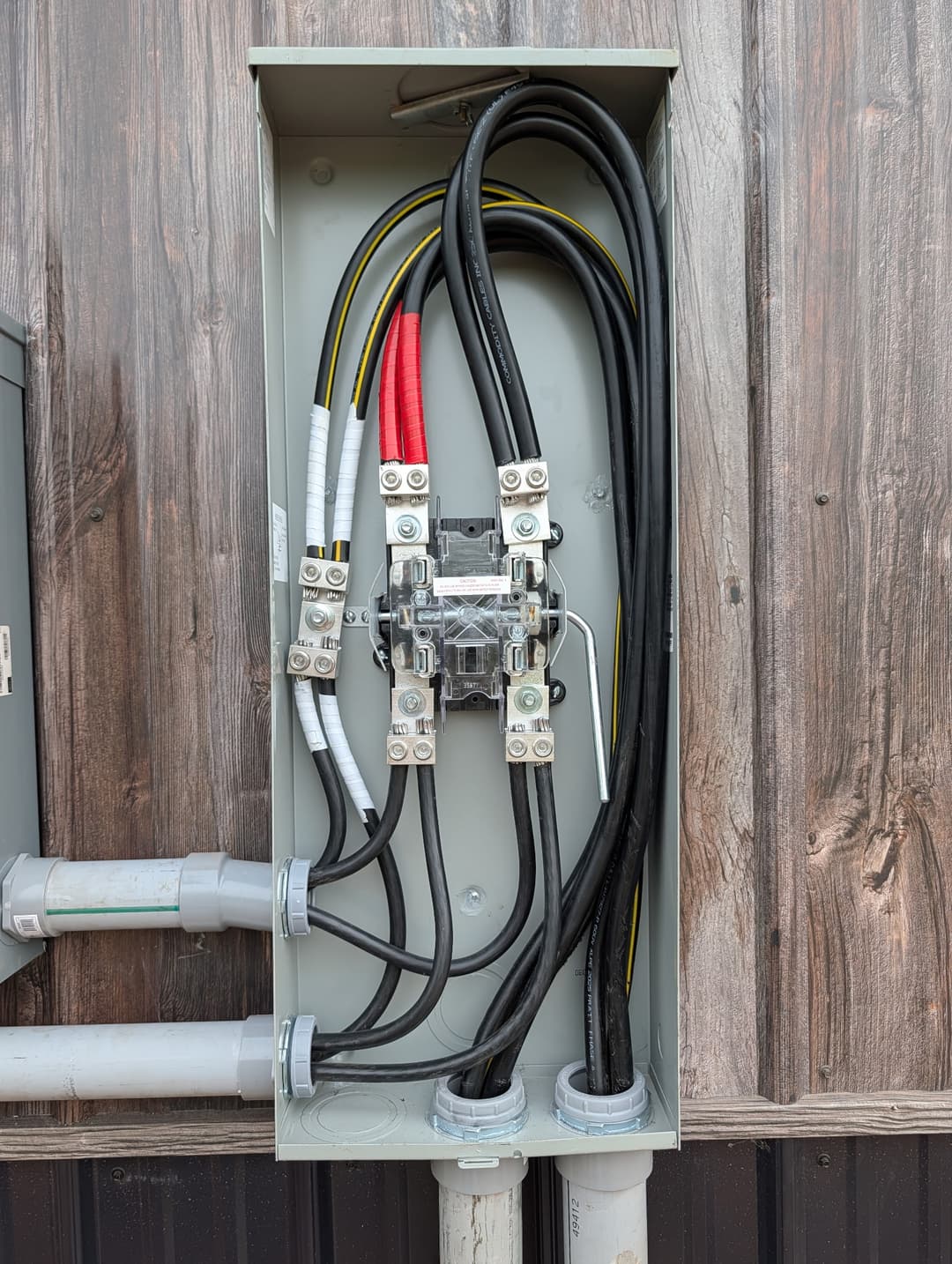 CT cabinet with heavy-gauge service conductors and lugs installed for a commercial electrical service.
