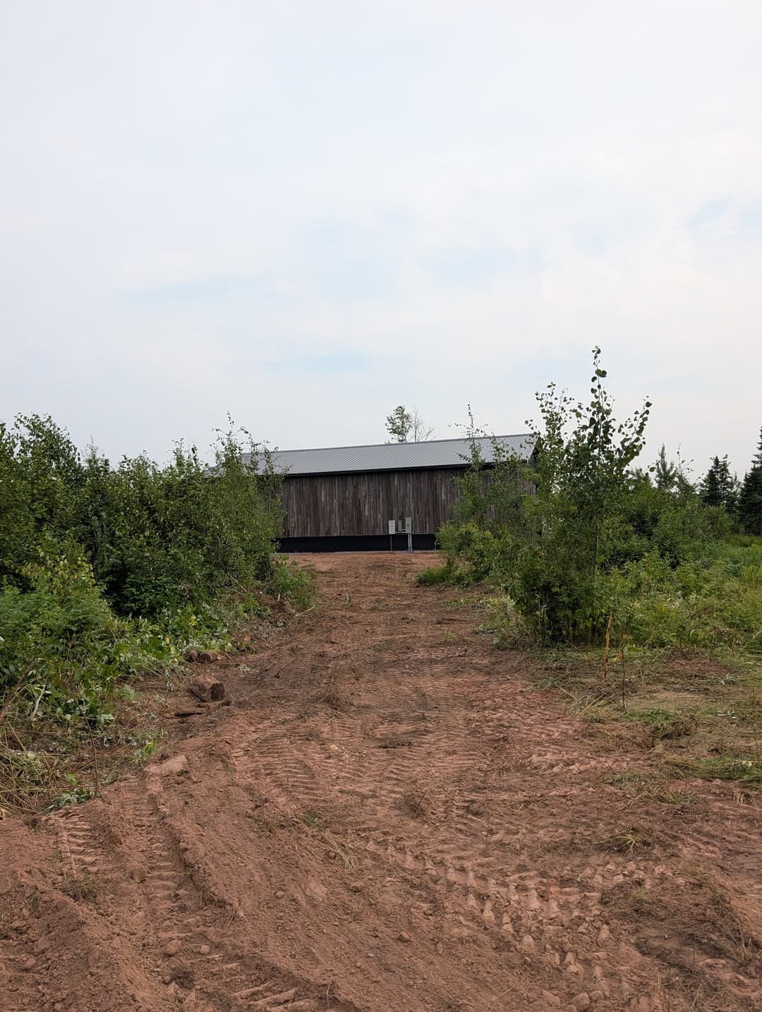 Completed electrical service installation on a pole building, viewed from the driveway on a Stateline Electrical project.