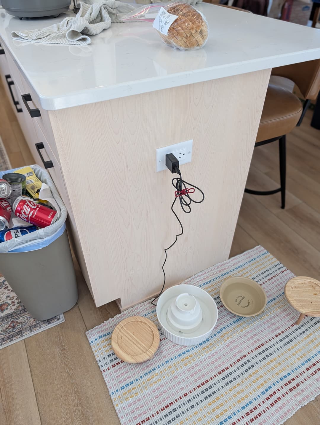 Electrical outlet installed at the base of a kitchen island for small appliances.