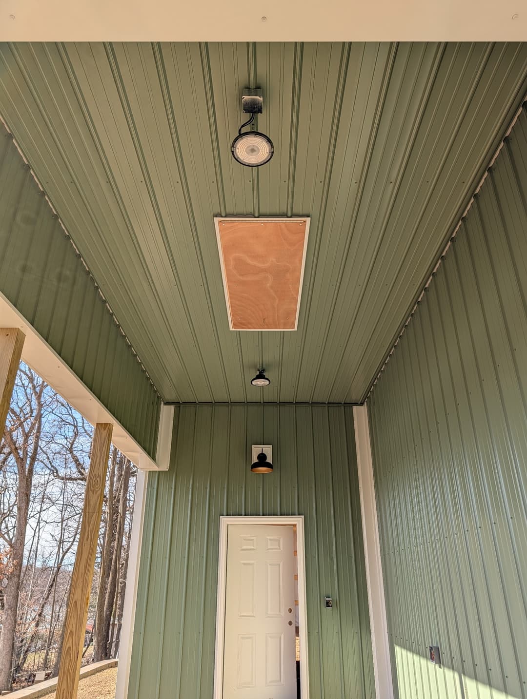 Exterior ceiling light and entry door wall sconce wired on a covered porch.
