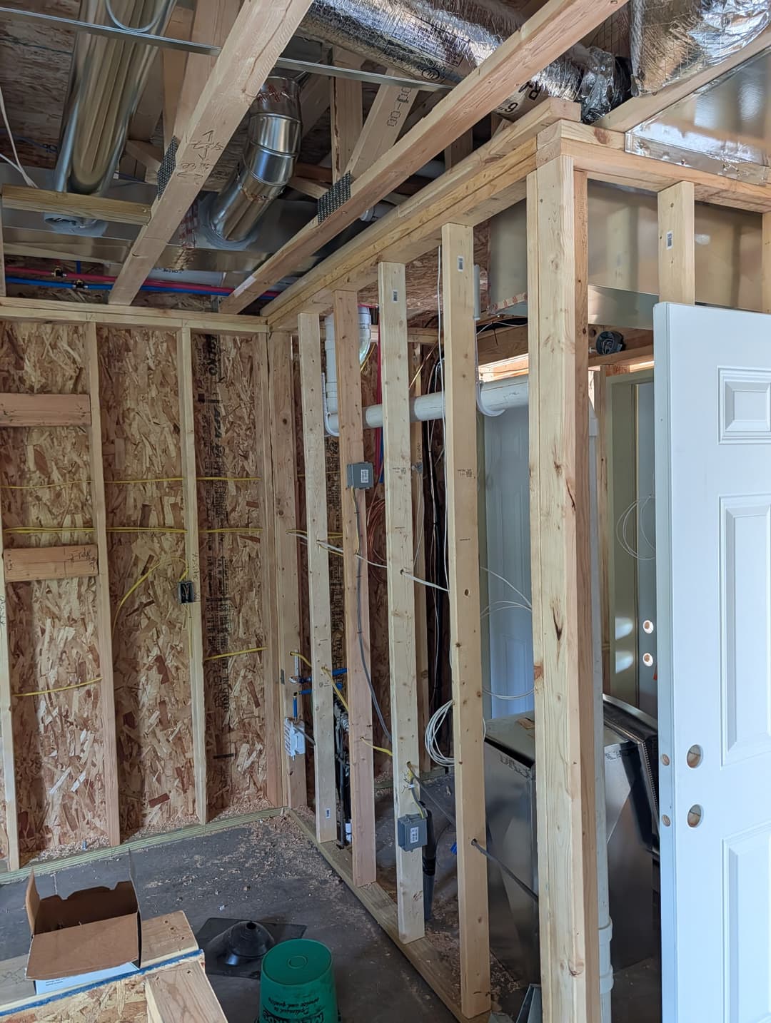 Ceiling wiring for recessed can lighting installed in a great room during new home construction.