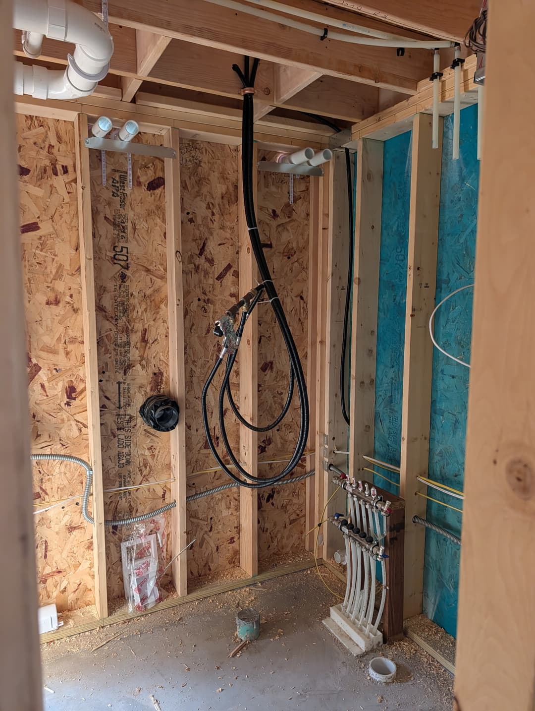 Flexible conduit whip and outlet boxes wired into a framed mechanical closet during rough-in.