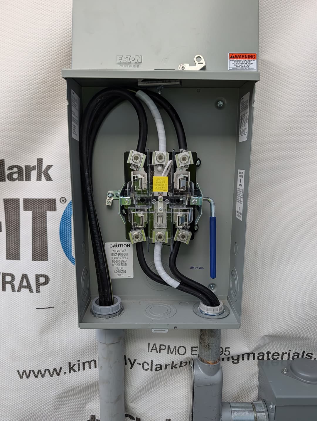 Eaton 200A meter socket and disconnect installed with service conductors landed and ready for inspection.