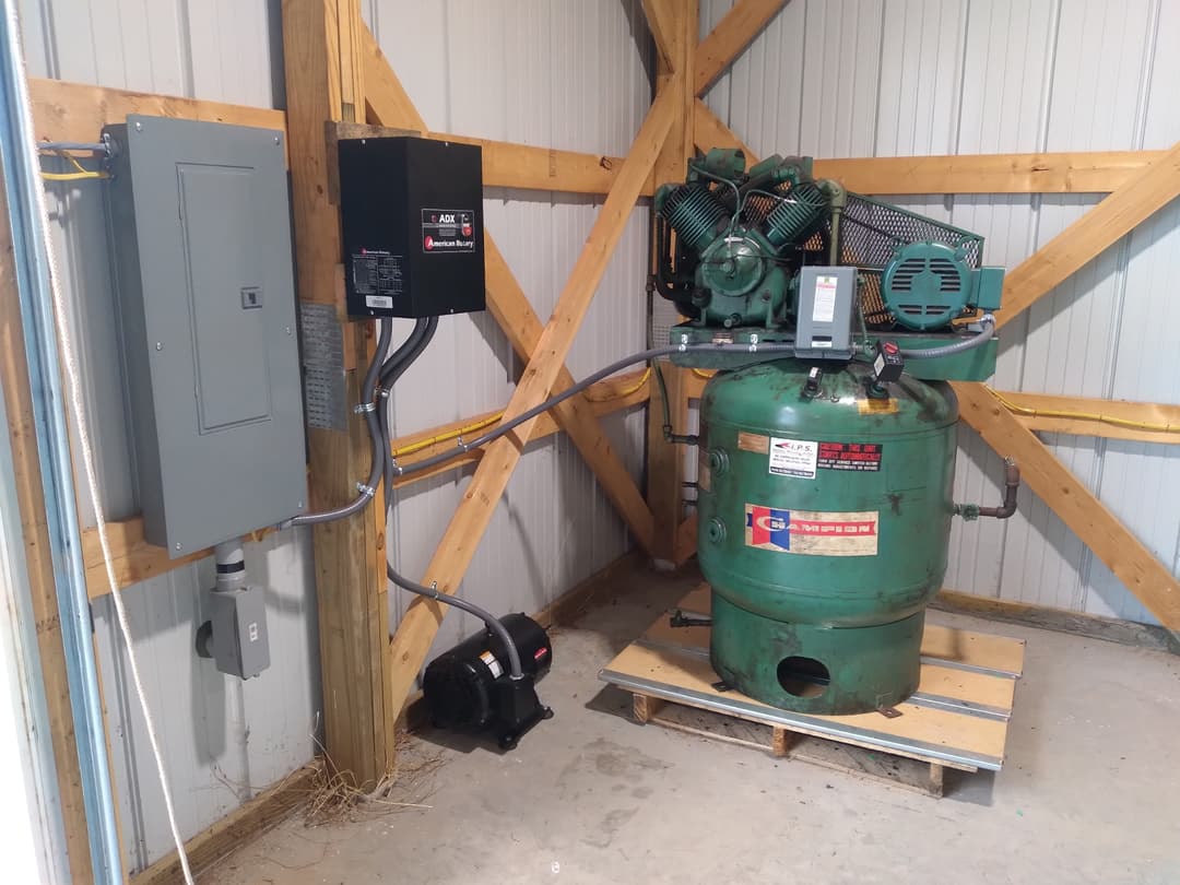 Close-up of an American Rotary phase converter and disconnect wired for a shop air compressor.